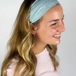 Woman wearing the Lost in Space headband, showcasing its versatile 3-in-1 twist style and buttery-soft, non-slip fabric, ideal for work or play.