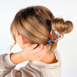 A woman with long hair wearing the A Different Angle Lilac Clip, a glossy hair accessory with a hinge closure.