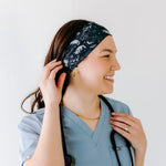 A nurse smiling with long hair while wearing the Gimme Some Space for cute hairstyles and comfortable all-day wear.