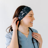 A nurse smiling with long hair while wearing the Gimme Some Space for cute hairstyles and comfortable all-day wear.