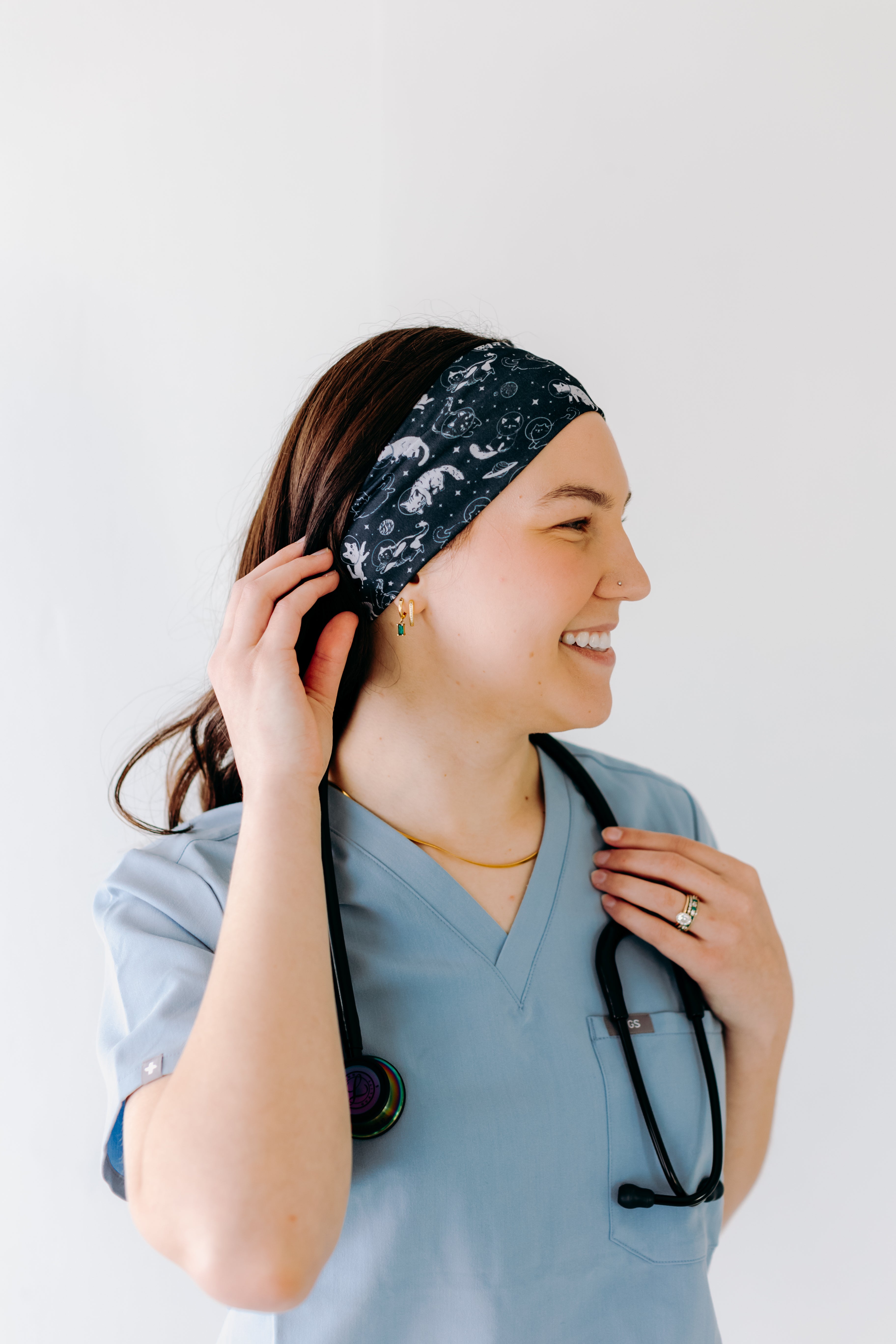 A nurse smiling with long hair while wearing the Gimme Some Space for cute hairstyles and comfortable all-day wear.