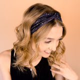 A woman wearing the Better in Black headband, a functional and versatile accessory for workouts, shifts, and play days.