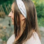 Sarah Floral on Ivory headband featuring a white base adorned with floral designs, crafted in a buttery-soft, ultra-stretchy poly-knit blend for versatile wear.