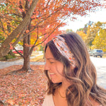 Woman wearing The One With All the Thanksgivings headband, smiling with her easy hairstyle. The headband is versatile, non-slip, and perfect for various activities.