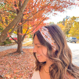 Woman wearing The One With All the Thanksgivings headband, smiling with her easy hairstyle. The headband is versatile, non-slip, and perfect for various activities.