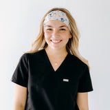 A nurse smiling with long hair while wearing theHeeler at Heart headband for cute hairstyles and comfortable all-day wear.
