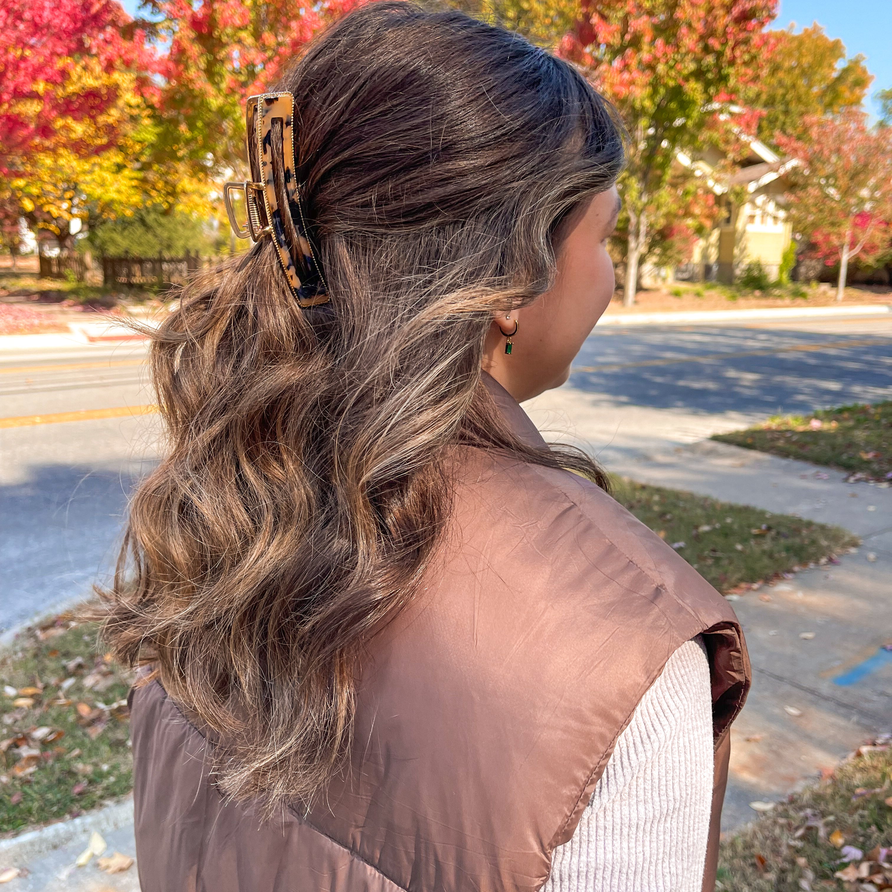 Woman with long hair showcasing the Fly Away Lilac Clip in her hair; a stylish 4.5-inch glossy metal accessory with hinge closure.