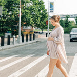 A woman confidently styling her hair with the No Rain, No Flowers Clip from The Sarah Wallace Collection in her hair.