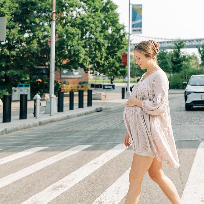 A woman confidently styling her hair with the No Rain, No Flowers Clip from The Sarah Wallace Collection in her hair.
