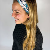 Woman wearing The Great Wave headband, showcasing its versatile 3-in-1 twist style and buttery-soft, non-slip fabric, ideal for work or play.