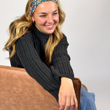 Woman wearing the Keely Floral on Black headband, showcasing its versatile 3-in-1 twist style and buttery-soft, non-slip fabric, ideal for work or play.
