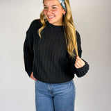 Woman wearing The Great Wave headband, showcasing its versatile 3-in-1 twist style and buttery-soft, non-slip fabric, ideal for work or play.