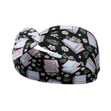 A Uniquely Portable Magic headband with a book and floral pattern, designed for confidence and functionality. Features include a 3-in-1 twist style, sweat-absorbent fabric, and a comfortable poly-knit blend. Sizes for women and children available.