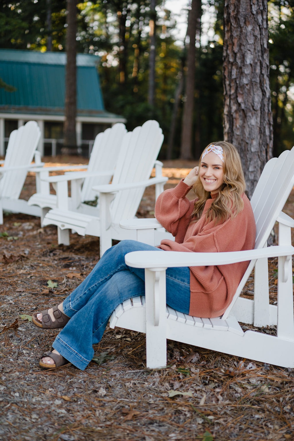 Woman wearing the Flourish headband, showcasing its versatile 3-in-1 twist style and cozy fall charm, part of The Jen Hamilton Collection.