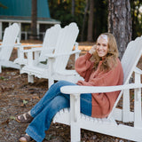 Woman wearing the Flourish headband, showcasing its versatile 3-in-1 twist style and cozy fall charm, part of The Jen Hamilton Collection.