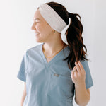 A nurse smiling with a long ponytail while wearing the Here to Save Your Butt for cute hairstyles and comfortable all-day wear.