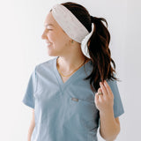 A nurse smiling with a long ponytail while wearing the Here to Save Your Butt for cute hairstyles and comfortable all-day wear.