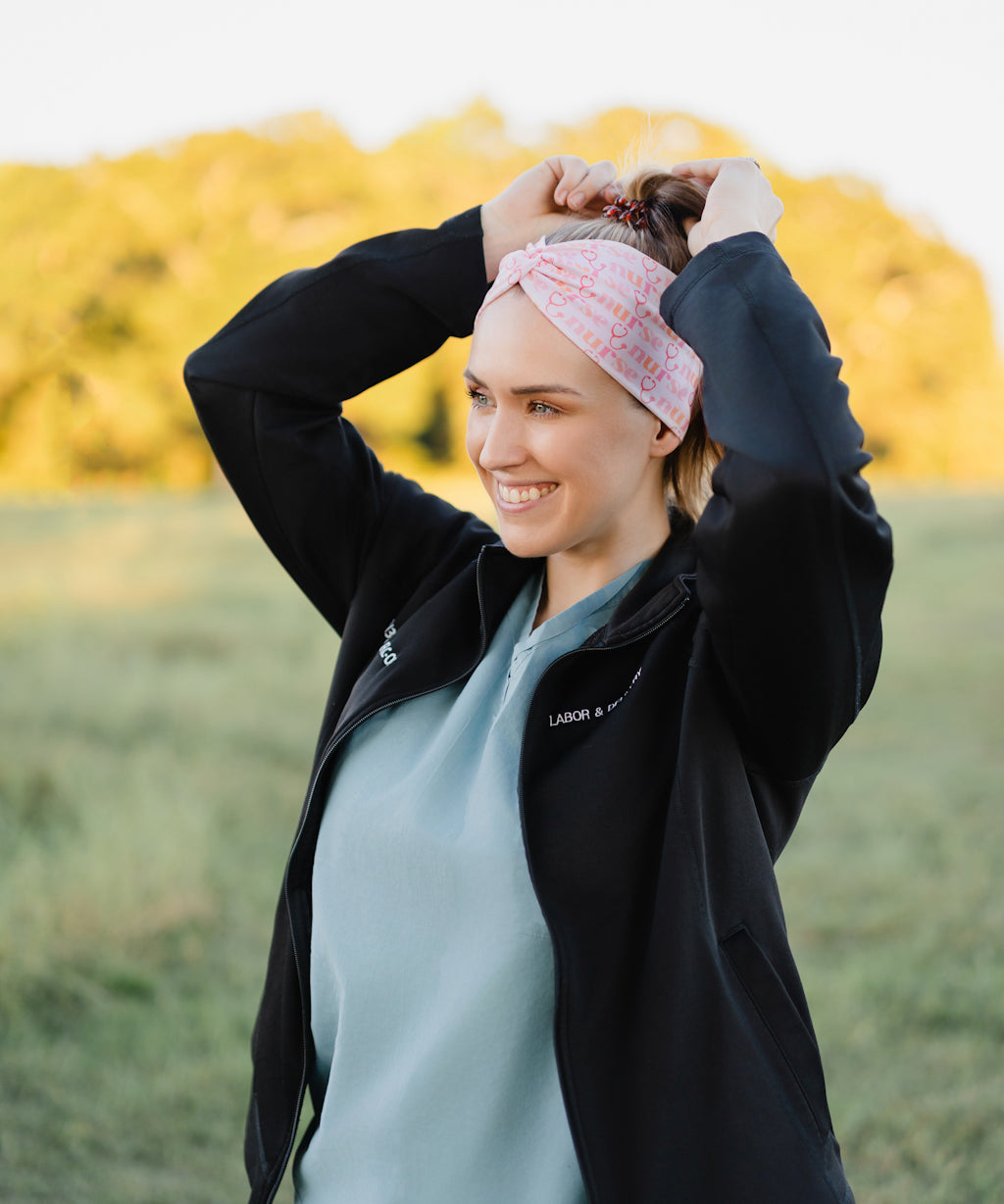 Woman in scrubs wearing a Nurse headband, showcasing its versatile, non-slip design, perfect for workouts or long shifts.