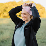 Woman in scrubs wearing a Nurse headband, showcasing its versatile, non-slip design, perfect for workouts or long shifts.