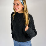 Woman wearing The Great Wave headband, showcasing its versatile 3-in-1 twist style and buttery-soft, non-slip fabric, ideal for work or play.