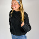 Woman wearing The Great Wave headband, showcasing its versatile 3-in-1 twist style and buttery-soft, non-slip fabric, ideal for work or play.