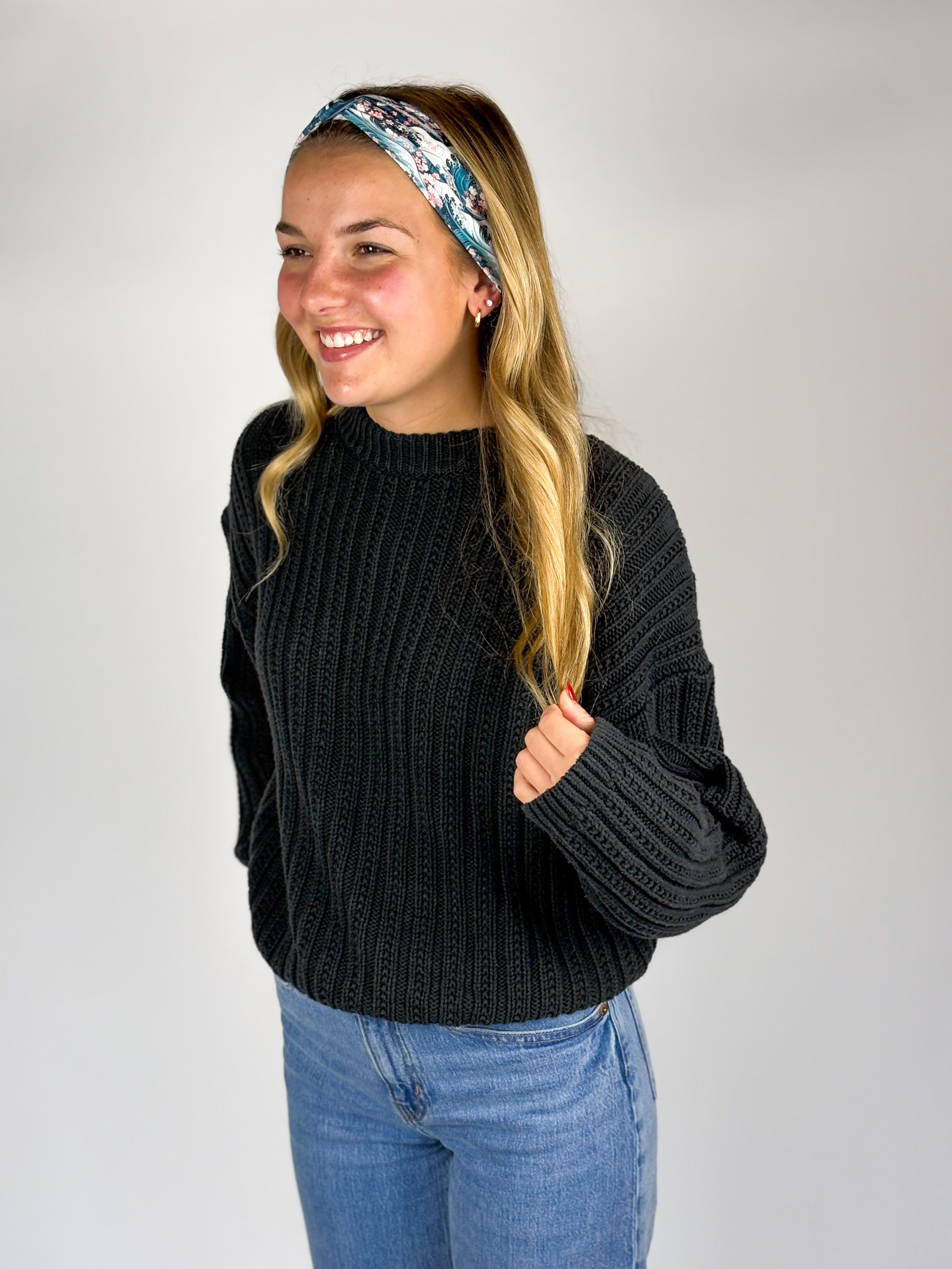 Woman wearing The Great Wave headband, showcasing its versatile 3-in-1 twist style and buttery-soft, non-slip fabric, ideal for work or play.