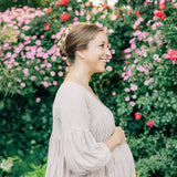 Woman wearing the Grow With Grace Clip from The Sarah Wallace collection, a 4.4-inch metal hair accessory with a flower design, securing her hair in a bun.