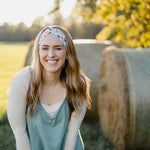 Hen & Harvest headband worn confidently by a woman with long hair, highlighting its twist style and versatility for workouts, long shifts, or play days.