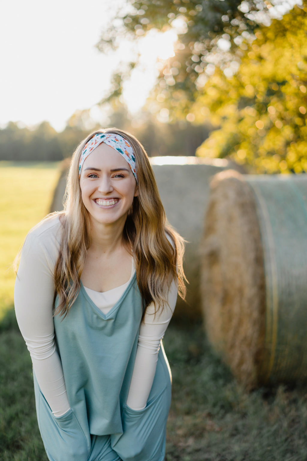 Hen & Harvest headband worn confidently by a woman with long hair, highlighting its twist style and versatility for workouts, long shifts, or play days.