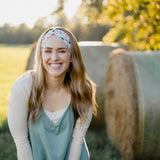 Hen & Harvest headband worn confidently by a woman with long hair, highlighting its twist style and versatility for workouts, long shifts, or play days.