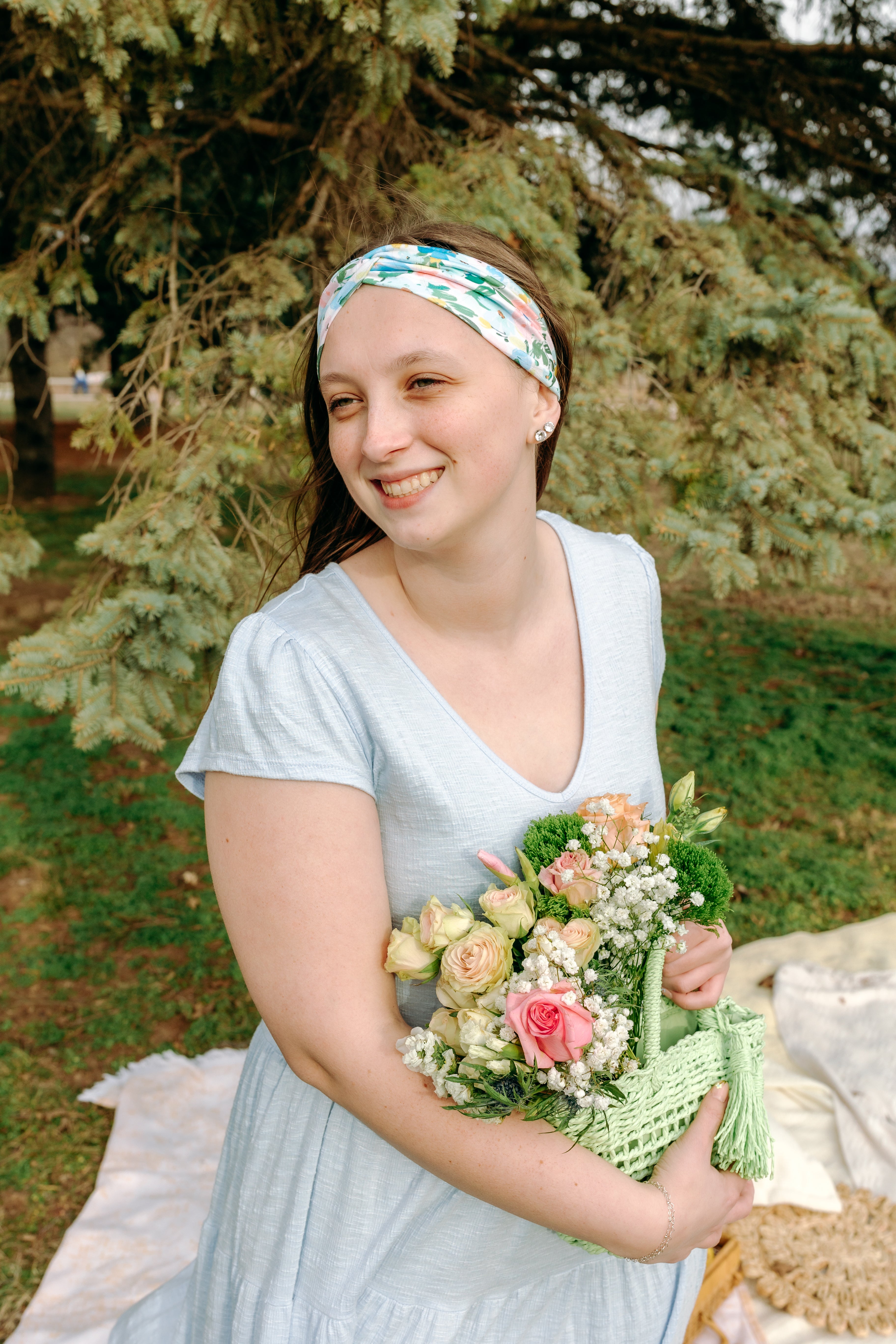 Woman smiling while wearing the Hope Floral on Ivory headband, the perfect non-slip accessory for work or workouts.