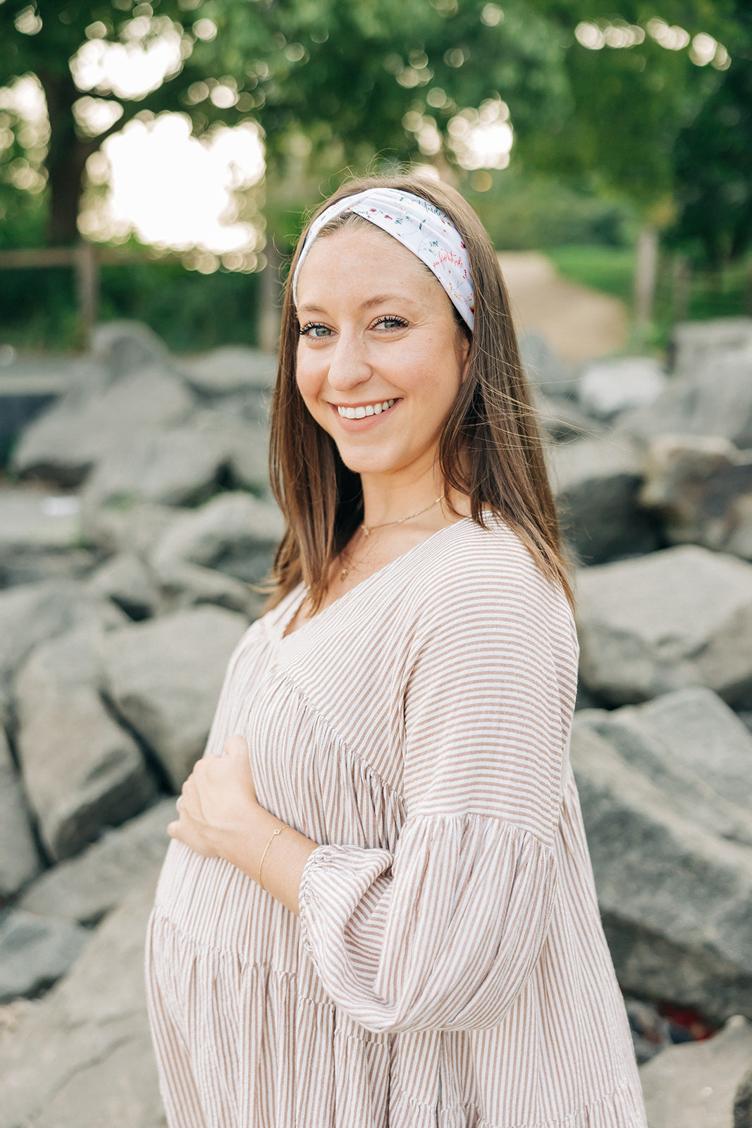 Woman smiling, wearing a Fortitude headband, showcasing its functional, versatile design. The headband is non-slip, sweat-absorbent, and perfect for workouts or daily wear.