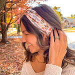 Woman wearing The One With All the Thanksgivings headband, smiling with her easy hairstyle. The headband is versatile, non-slip, and perfect for various activities.