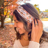 Woman wearing The One With All the Thanksgivings headband, smiling with her easy hairstyle. The headband is versatile, non-slip, and perfect for various activities.