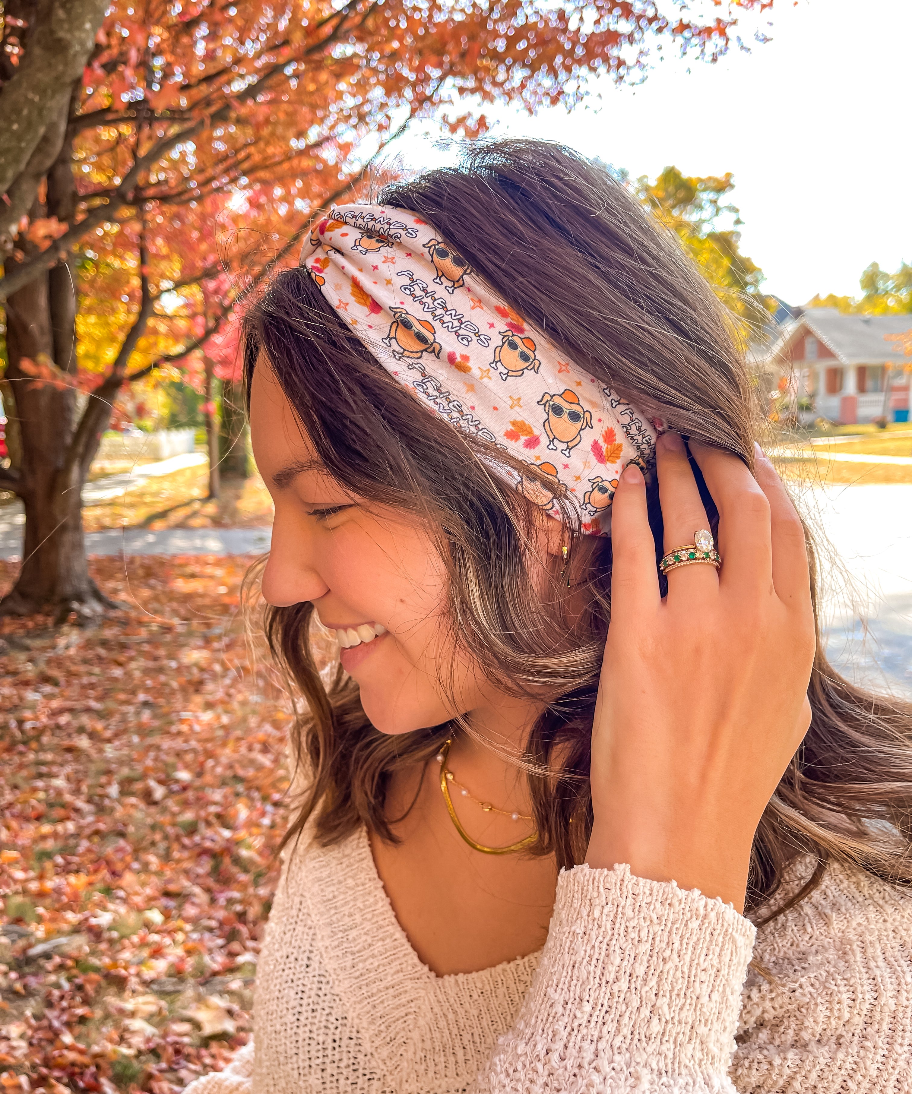 Woman wearing The One With All the Thanksgivings headband, smiling with her easy hairstyle. The headband is versatile, non-slip, and perfect for various activities.