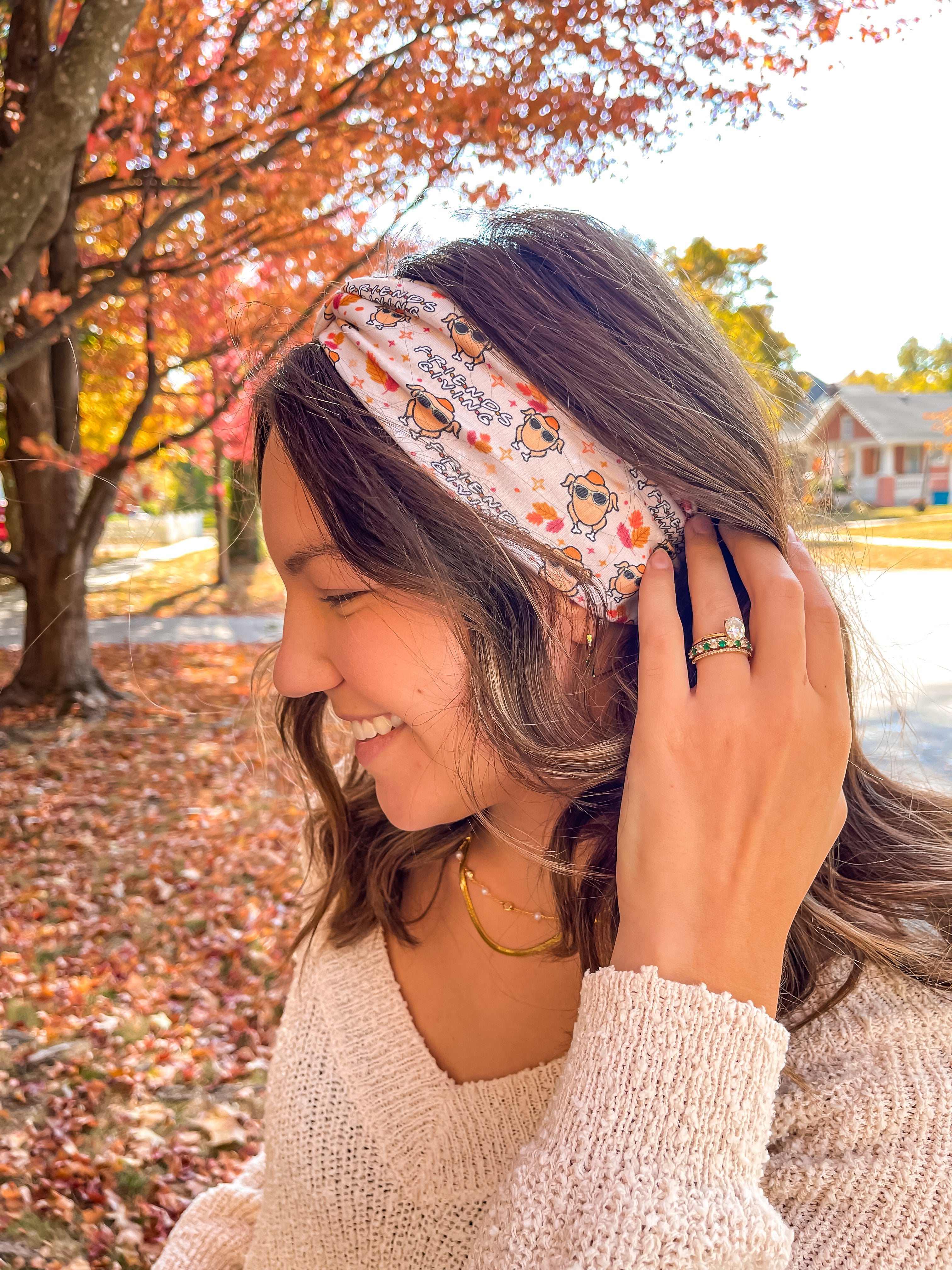 Woman wearing The One With All the Thanksgivings headband, smiling with her easy hairstyle. The headband is versatile, non-slip, and perfect for various activities.