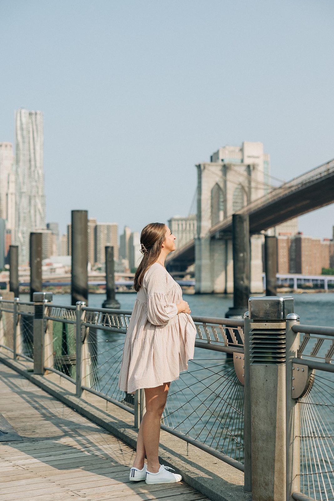 Woman wearing the New York Minute Lilac Clip, a 4.2-inch metal hair accessory from The Sarah Wallace Collection.