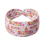 Birthday Specialist headband with confetti and birthday hats on pink fabric.