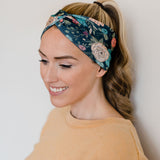 Adult women's black headband with hand-drawn gold, teal and coral roses with green stems and leaves