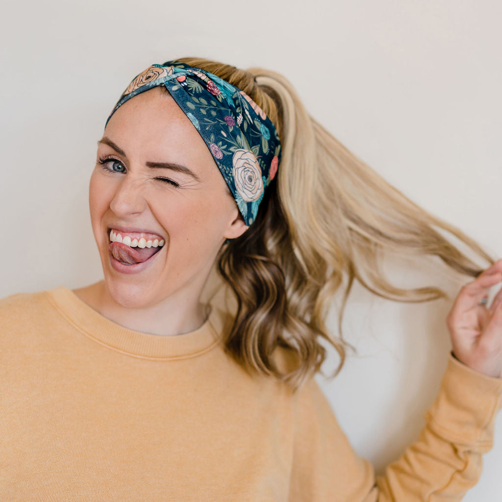 Adult women's black headband with hand-drawn gold, teal and coral roses with green stems and leaves