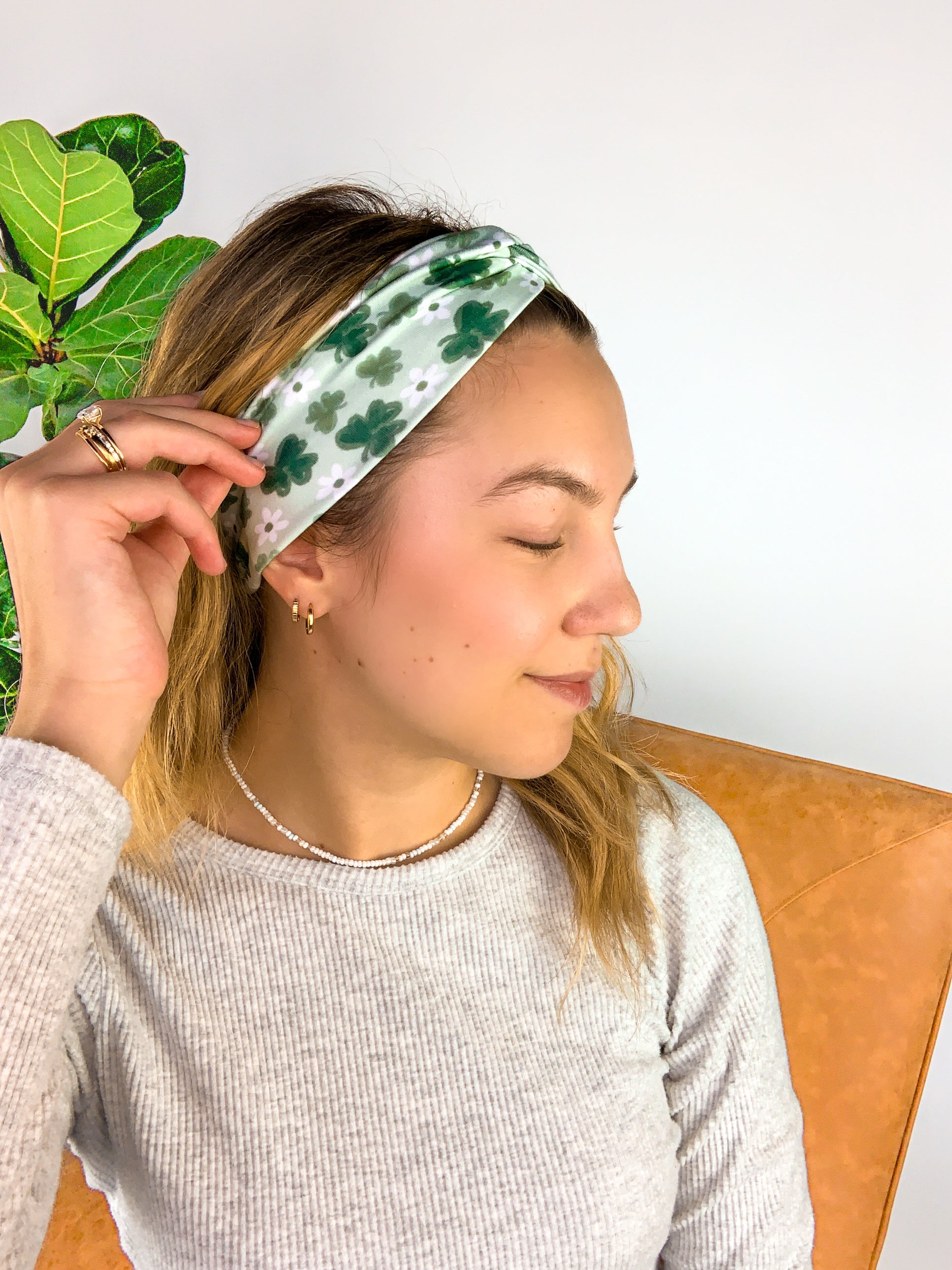 A woman wearing a Pinch Proof Lilac Market Headband, showcasing its functional and stylish design for confident wear during various activities.