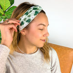 A woman wearing a Pinch Proof Lilac Market Headband, showcasing its functional and stylish design for confident wear during various activities.