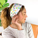 A woman wearing a You're My Lucky Charm headband, showcasing its functional and versatile design for confidence in any activity.
