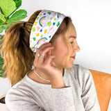 A woman wearing a You're My Lucky Charm headband, showcasing its functional and versatile design for confidence in any activity.
