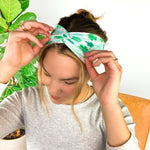A woman wearing a In My Lucky Era Headband, showcasing its functional and versatile design for confidence in any activity.