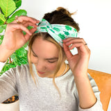 A woman wearing a In My Lucky Era Headband, showcasing its functional and versatile design for confidence in any activity.