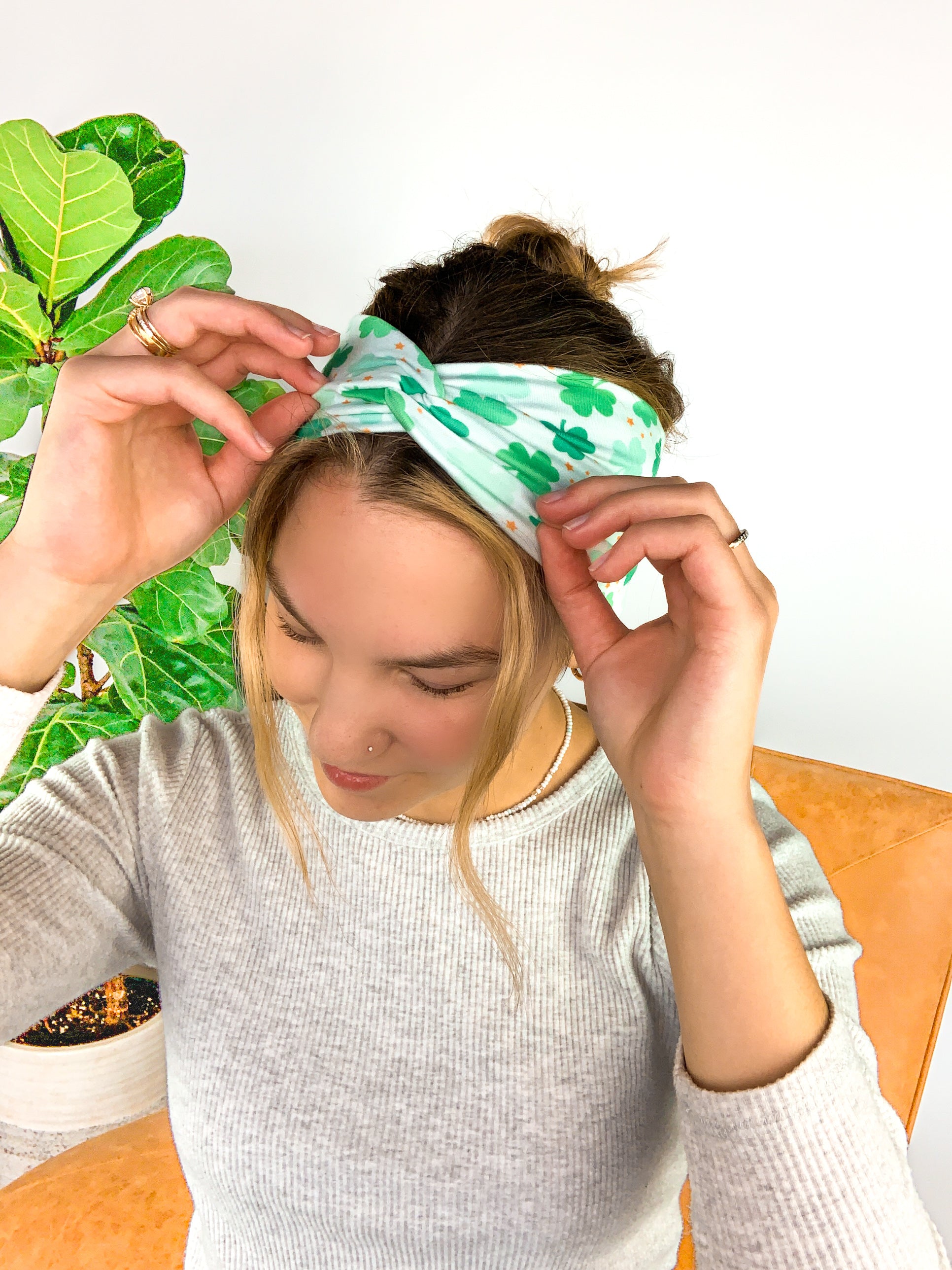 A woman wearing a In My Lucky Era Headband, showcasing its functional and versatile design for confidence in any activity.