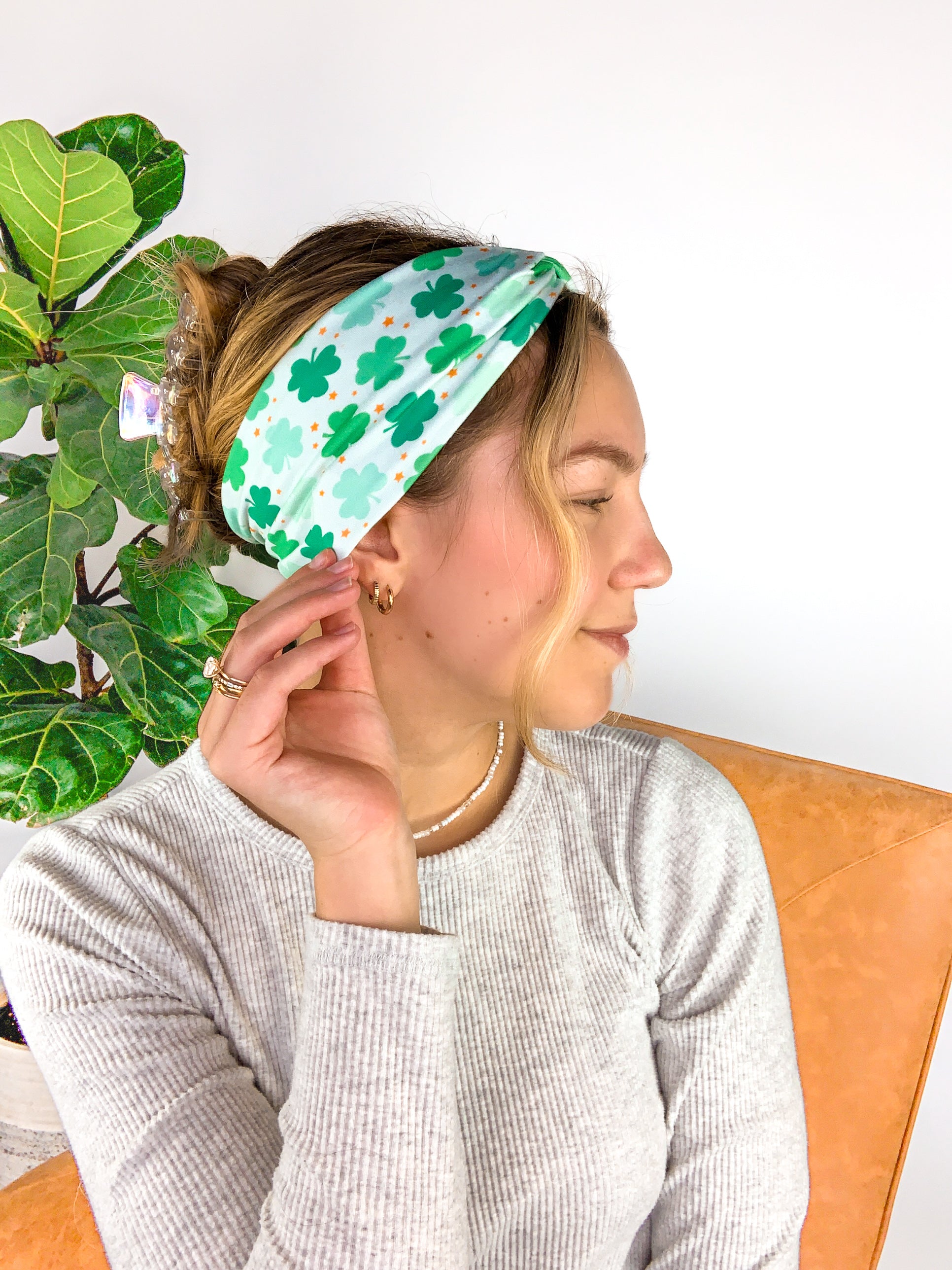 A woman wearing a In My Lucky Era Headband, showcasing its functional and versatile design for confidence in any activity.