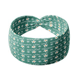A green headband with white flowers and script saying "neonatal intensive care unit", designed for confidence and functionality. Versatile twist style, sweat-absorbent, non-slip, machine washable. Ideal for workouts, shifts, and play.