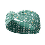 A green headband with white flowers and script saying "neonatal intensive care unit", designed for confidence and functionality. Versatile twist style, sweat-absorbent, non-slip, machine washable. Ideal for workouts, shifts, and play.